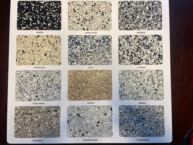 A sample board displaying twelve different speckled and textured epoxy floor coating color options.